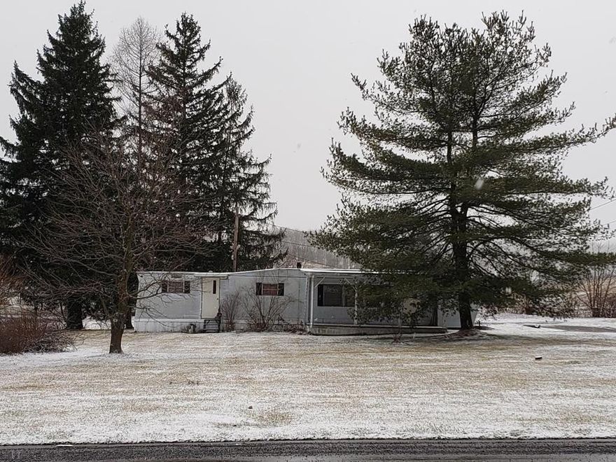 1963 2-bedroom 1-bath mobile home on .74 acres in Hollidaysburg School District (2 side-by-side lots).  Move in or build your own home since public water & sewer are already there.  Also good location for a business.  If buyer is moving trailer, check with Blair Township for permits and SALDO ordinances.  SOLD AS IS.  J-506