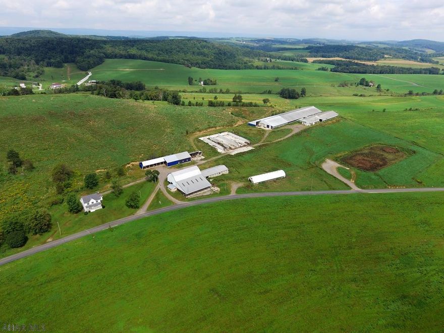 197+/- Acre farm with dairy complex consisting of a large freestall barn of 590+ stalls, milking parlor/milkhouse with special needs area, multiple outbuildings, large bank barn, horizontal silos, and earthen manure pit. Property at one time supported a 600 head dairy operation. This property is Bank Owned. Tax ID #s S42-004-026-04 & S42-044-042-04.