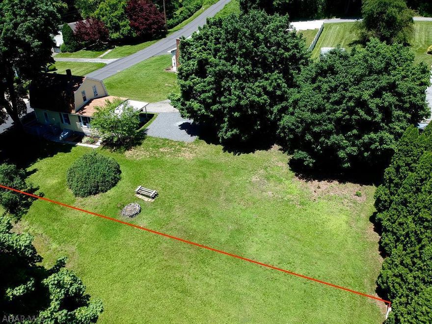 Carefully remodeled from top to bottom, this 2 bedroom home is a must see! The kitchen is open to the rest of the first floor and has ample cabinet space, a tile backsplash, and included stainless steel appliances.  There is a room on the 1st-floor that could be used as a bedroom with sliding doors and a large closet.  There are 2 bedrooms upstairs and a full bath with custom tile work and a granite vanity top.  The home is situated on a large lot with plenty of parking space.  Red line represents approx property line.  Additional lot is available - list price for both lots and house is $125,000.