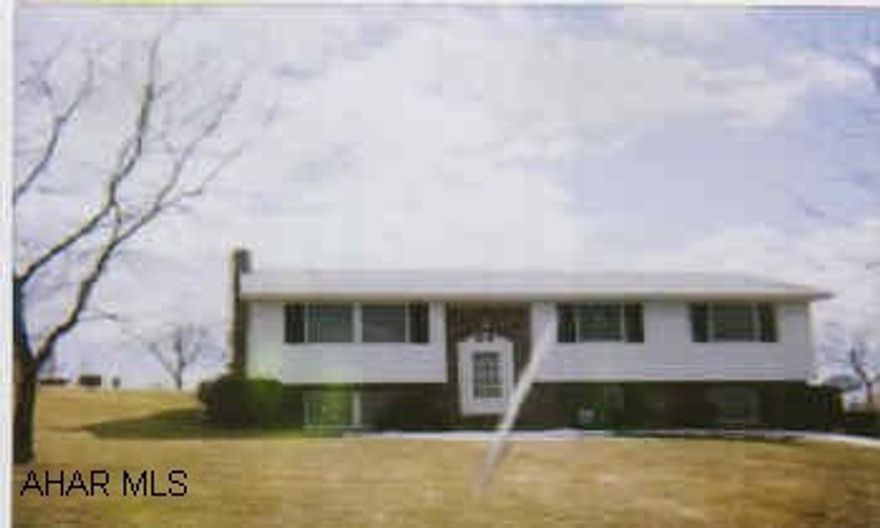 Lovely bi-level, family room with woodstove, landscaped lot, shed and workshop.