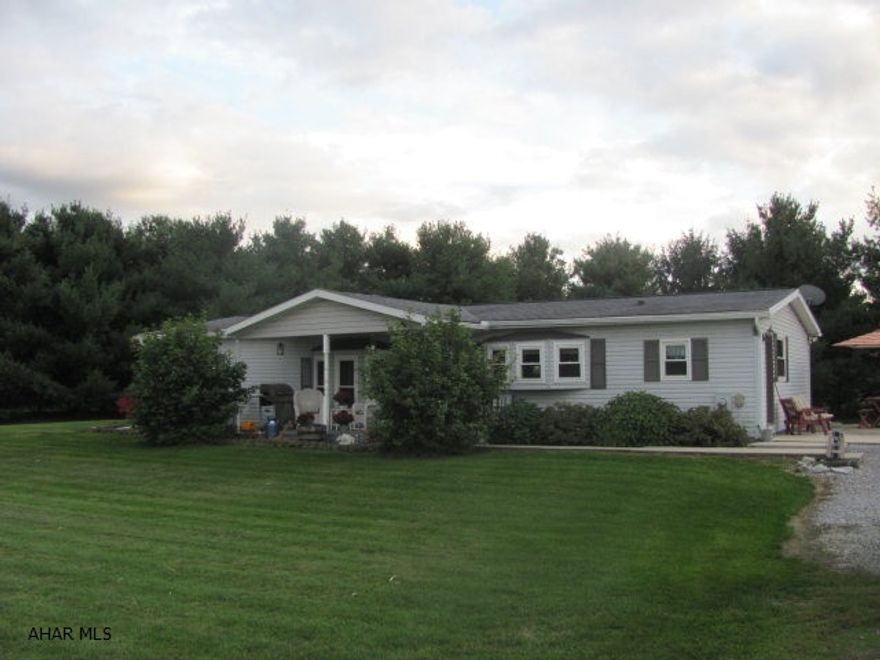 Well maintained home in a private country setting in the NBC school district. This(1989)Doublewide manufactured home has been updated and well maintained. The roof was replaced in 1997, a front porch was added and covered with a new roof, new gutters were installed in 2015, new energy efficient windows were placed in home in 2013, a new furnace in 2013, a small propane wall unit heater was built into the home in 2013 for alternative heat in case of power failure and the Master Bathroom was remodeled in 2010. This home sits on a complete Cement block basement that could be finished to your desires. Mature trees on three sides of home provide you with privacy on this one acre level lot.