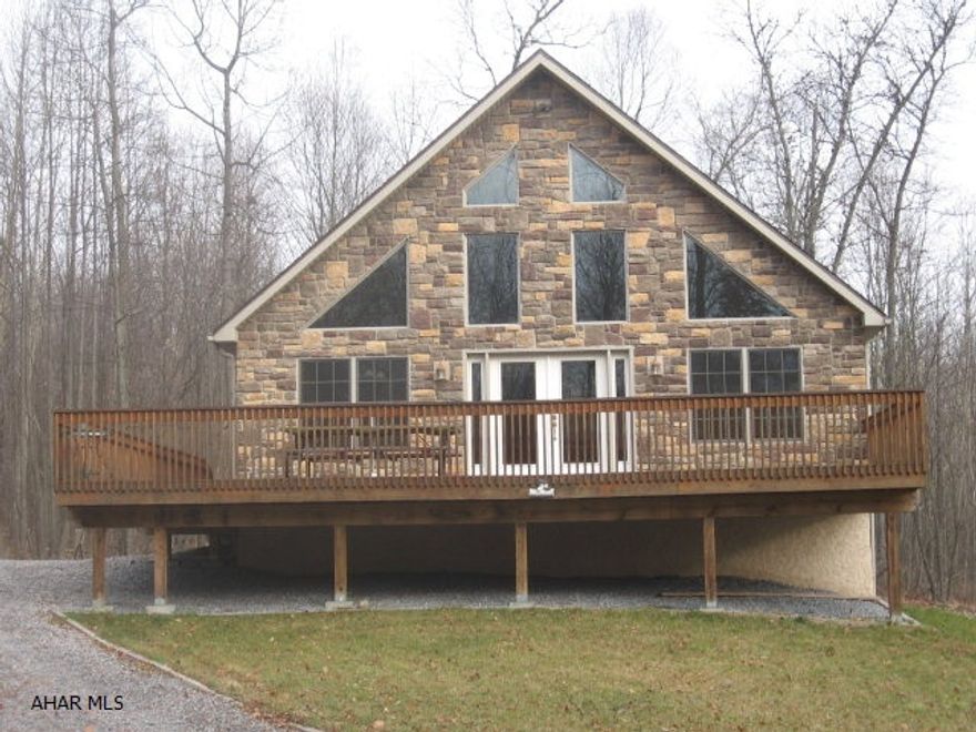 One of those rare finds! A very quality-built Chalet on two acres just 5 minutes from Shy Beaver boat launch.  It's tucked into the woods in a semi-private setting with abundant wildlife. This 3 BR/2 Bath home is on 9.5 poured foundation, 2x6 walls & 2x12 rafters, stone on the front & fireplace. Ash hardwood, vaulted ceiling w/pine tongue and groove, floor to ceiling stone fireplace w/gas insert, lots of stained solid wood windows, doors & woodwork. A kitchen of 42 tall hickory cabinets and SS appliances w/recessed lighting under cabinets & throughout living area. The MB has sliding doors to 10x10 deck. Oak railing and 4' wide steps lead to loft area and bedroom on the 2nd floor. The lower level has a 30x19 rec room w/stone wall, gas stove, 3/4 bath. Many extras!!