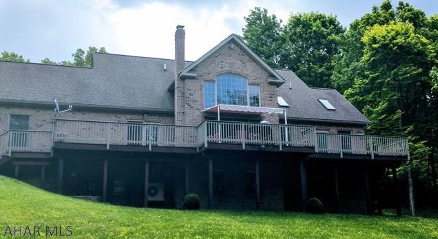 See this home in 3D and watch the custom luxury property video on the Brokerage website! It's a beautiful 5 BR, 4 BA brick home, with wrap around porch and a large back deck, nestled in the hills near Omni Bedford Springs Resort. The home sits on nearly 10 acres of private land. The great room is the show piece of this house, with cathedral ceilings and a loft space that features 2 bedrooms and a full bath. The large master bedroom has a walk in closet & a spacious master bath that opens out into a sunroom. New hardwood floors in the master in rich dark wood. The fully finished basement is entertainment central with a theatre room, bar and a wood burning fireplace. This home truly has it all!