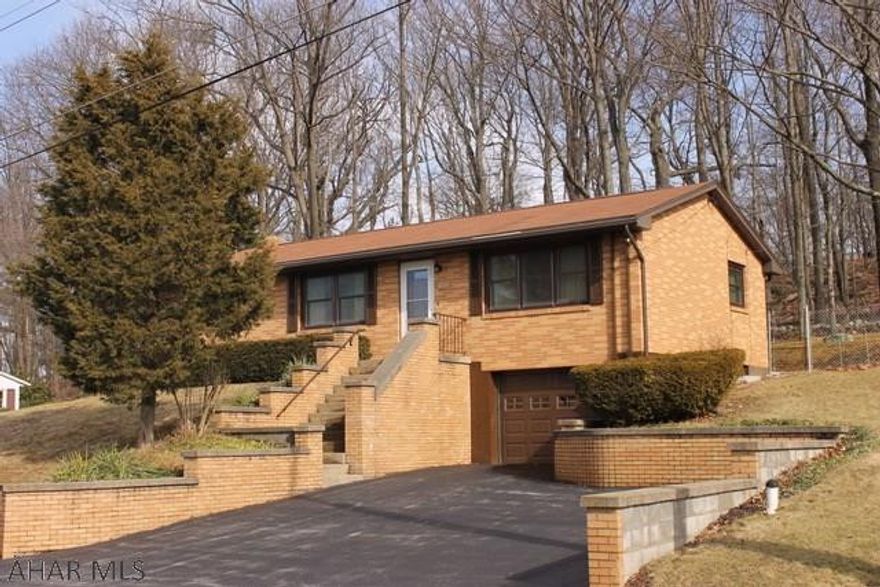 Well maintained, raised brick ranch with a fabulous view. Features include: hardwood floors, central air, fenced yard, partially-covered deck, large lot (100' x 114'), 1 car garage, family room w/ bar, new shower in basement, small workbench area, walk-up attic, triple pane UV protection argo gas insulated windows in front (2008), triple pane windows in back (2012), PA waterproof system (interior French drain) 7 years ago, and a newer high efficiency condensing gas forced air furnace (2004).