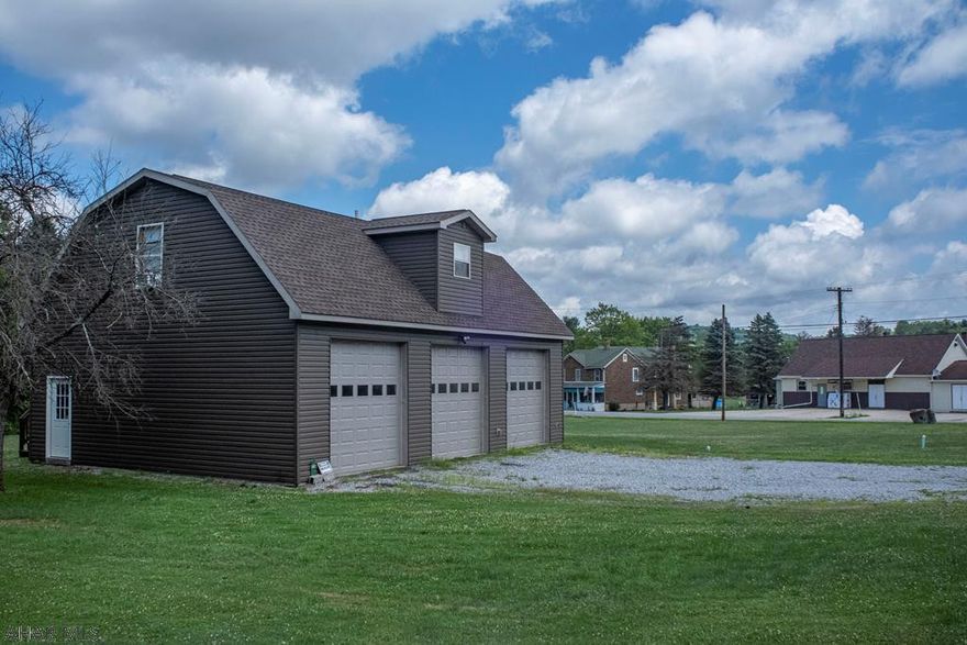 A unique find! If you have a lot of toys and you need space to put them, this property is for you! It's a newly built home above a massive 3 bay garage on 3 corner lots in Smoke Run! Nearly 2 acres total! The heated garage is completely finished and includes garage door openers, plus a laundry/furnace room. Above the garage, you find a new, 1 bedroom, 1 bath home with an open concept entry, living room, dining room and kitchen. The kitchen has newer stainless steel appliances and ample cabinet space. Luxury vinyl plank flooring throughout! Plus an updated bathroom. Check out the wildlife from your back deck! Two large lots on either side of the house are included! Build your dream home and have a place to stay while you do it! Or, enjoy it as is! Fruit Trees and a small stream too!