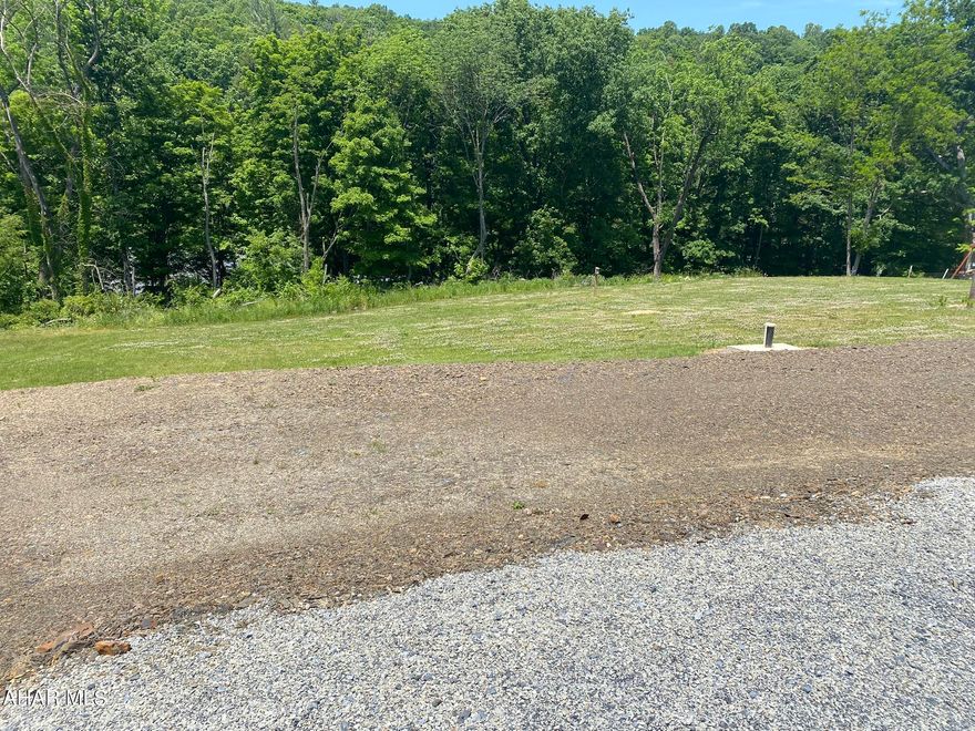 Beautiful acreage with all utilities just shy of 1.5 acres in Broad Top Township. Start building your dream home or summer cabin on this land! Well, public sewer and electric already on site. Would make a beautiful getaway in close proximity to Raystown Lake, with plenty of boat parking! Shed will remain which houses all well equipment including conditioning system. Garbage in Broad Top is free! Just one of the many perks of living on your private land in this area. So many possibilities for this property.