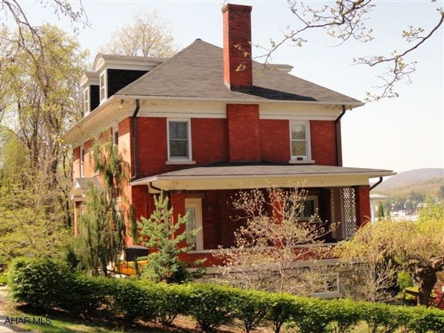 Gorgeous stately, red brick 2 1/2 story home, located on a beautiful double lot in a lovely older neighborhood.  3-4 bedrooms and 2 full and 2 half baths.  Beautiful foyer with fan-glass transom, beveled glass side-lites and beautiful original oak trim and staircase.  Living room with oak fireplace and mantle, hardwood flooring and french doors leading to a covered side porch.  Remodeled kitchen with cherry cabinetry, wet bar and ceramic tile.  Extra large master bedroom with study and loeads of stroage and built-ins.  Third floor guest room or bonus roomw ith 3/4 bath.  Finished basement with family room, laundry room a d walk-out.  Large 2 story detached garage with heated workshop above.  Covered deck and patio area.  Wonderful landscaping and extra large private yard.