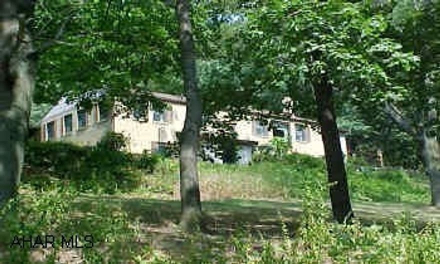 Gorgeous secluded setting!  Brick rancher with fireplace (in living room), newer cherry kitchen, and newer bath.  Finished room above the 2-car garage possible for office or workshop.  Coal, oil baseboard, and wood heat.  Private deck and 2 picnic pavilions. SELLER SAYS SELL!