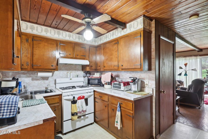 TRULY REMARKABLE! Seller has taken impeccable care of this cozy home that sits on an impressive 29 acres. You'll love all the natural sunlight in the dining room thanks to newer windows and patio doors. The kitchen makes excellent use of the space with a butterfly sink, plenty of cabinets, and ample countertop space. All appliances included! The wraparound deck overlooks the backyard and most of acreage, providing serenity for enjoying your morning coffee or the perfect place for entertaining on those summer afternoons that are just around the corner. An additional deck can be found through the 2nd set of patio doors in the living room. One-floor living is even possible with a first-floor bedroom and full bath. Upstairs you'll find the primary bedroom with its own private balcony and also the 3rd bedroom. Enjoy the current use of free gas for heating and cooking, well water, and a septic system... all of which combine for extremely low cost of living! Don't wait to tour this ONE!!!