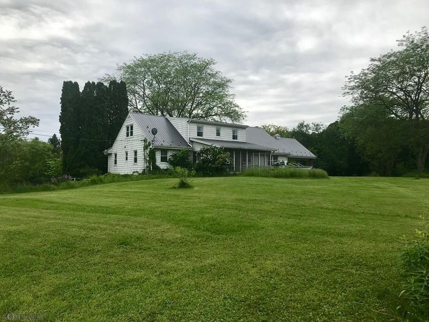 This home is a must see to appreciate. Once you enter your driveway, you'll feel like you've entered your very own "Southfork" as you approach this solid, well-built home on 5 acres. This home boasts an open spacious floor plan and endless possibilities. You won't be short on space or storage inside or out. Luxuriate in large spacious rooms with a lot of natural light and original hardwood flooring throughout. Warm up in the living area with the wood burning fireplace and enjoy the view from the large picture window. Indulge yourself in the fruit from your own apple and pear trees while relaxing in the large screened porch. And what you could do with the full partially exposed basement is limitless. Don't miss out, schedule a showing today.