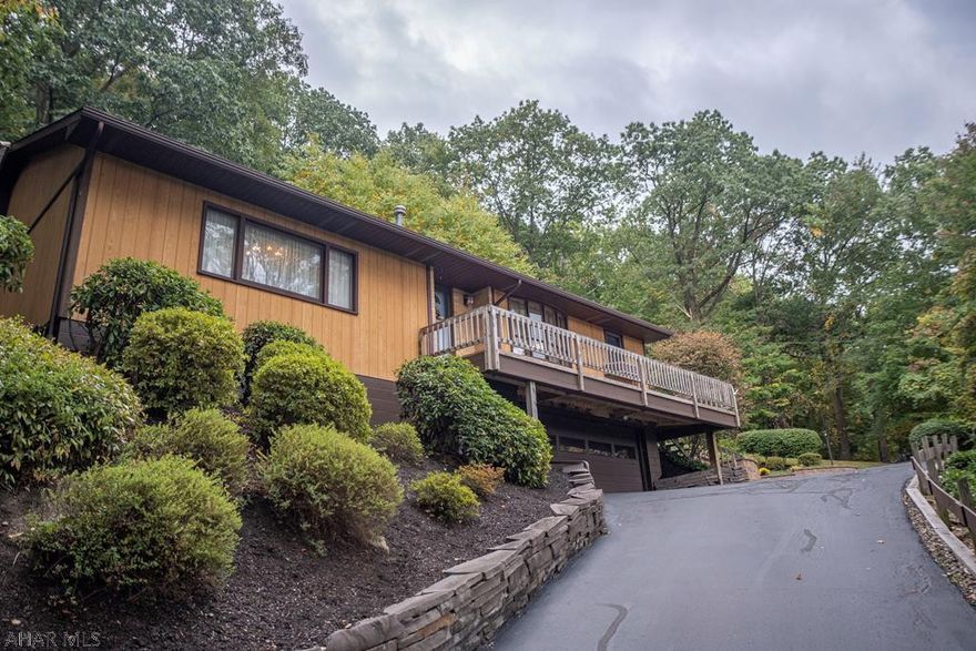 NEW PRICE! Discover this impeccably maintained raised ranch home in Altoona! Luxury meets comfort in this beautiful three bedroom, two bath home with a two car garage, fantastic views and a lush landscape. The home sits on close to 2 acres, surrounded by woods. You can enjoy relaxing on your secluded back deck, custom tile covered patio or private lawn. Inside, you'll find an open concept kitchen and dining area with hard wood floors, a spacious living room with a marble floor entryway, custom cabinetry and a gorgeous fireplace. The master bedroom offers an updated full bath. And downstairs, you have two bonus rooms that offer additional living or storage space and a laundry area. 3D tour on broker website.