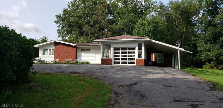 Step back in time inside this fabulous mid-century home!  Many original features throughout.  An enclosed, live-plant atrium welcomes you.  Spacious home - much larger than it looks.  Generous storage.  Master bedroom has an attached office/nursery/bonus room.  Enjoy just over 2 acres in this lovely setting convenient to town.