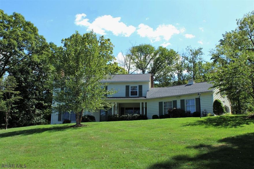 Distinctive 2-story 5BD-2 full/2 half BA home in a great location close to town and schools. Formal LR with wood FP; DR with built-in cabinet; foyer w/ slate floor, double-door entry. Beautiful hardwood flooring. Master BR Suite w/ HWD floor, tiled bath w/ double vanities. Brightly light renovated eat-in kitchen w/ floating island, built-in appliances and large pantries. Spacious garage w/ shop area and basement access. Basement w/ rec-room, wood FP, 1/2 Ba plus office/BR. Hillside setting on 1.3 acres in Meadow Brook Terrace. Major up-dates: roof, windows, furnace, AC plus several freshly painted rooms.