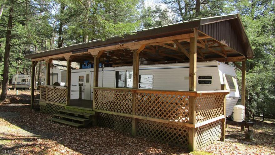Spacious deck adds extra living space to this large Dutchmen camper.  Slide out in the living room means space to live without being cramped.  Sliding doors onto deck brings light and added access to the outdoors.  Shed for keeping your toys and tools.  Located in Glendale Yearound, a gated recreational development.  Furnace needs serviced.