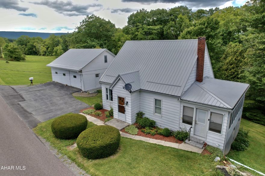 This three-parcel country property has a total of 25.25 acres with a combination of rolling fields, wooded areas and a stream at the rear of the property. The cape cod style home has a spacious sunroom with plenty of room for lounging or extra storage, a convenient first floor bedroom and bathroom, second floor bedrooms with beautiful wood floors and loads of storage areas. New metal roof just done Spring of 2023. Huge four-car garage with blacktop parking and other outbuildings to store your toys or equipment add to the reasons you'll love this home. Offering As is/Where is. Call to schedule your tour.