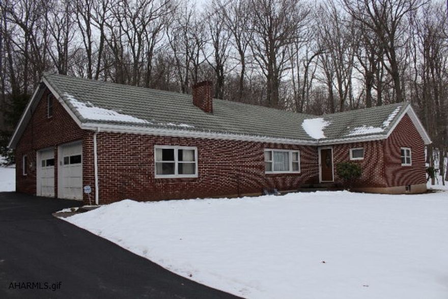 You want privacy and you want it close to town. This home is 2.7 miles from Pleasant Valley Boulevard and has 6.5 acres. Enjoy near maintenance free living with a brick exterior and a metal roof. Enclosed back porch/sunroom and a 2 car garage. Ready for you to finish the attic and basement for additional living space. Wood burning fireplace and hardwood floors throughout. Updated bathrooms are a nice touch for this home.