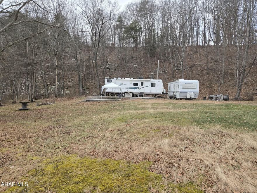 Explore 25.05 acres of recreational land with established four-wheeler trails, a camper pad with two 30-amp camper plugs, existing well and sewer, and beautiful Longs Run Creek running through the property. Ideal for recreation, camping, or future plans.