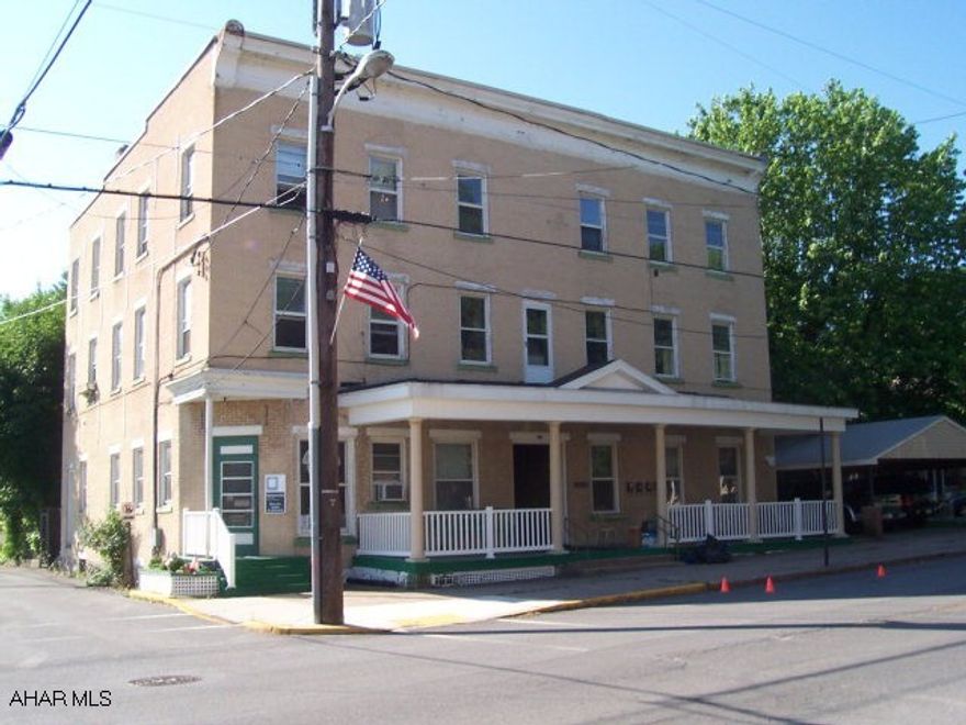 Formerly the Williamsburg Hotel.  Many possibilities with the 8 Unit Building including 3 Commercial Office Spaces and 5 apartments.  Currently 1 office is rented and 2 apartments also, owner pays heat, water, sewer - tenants pay electric and trash.  Opportunity to own a piece of history.  Owner financing available.