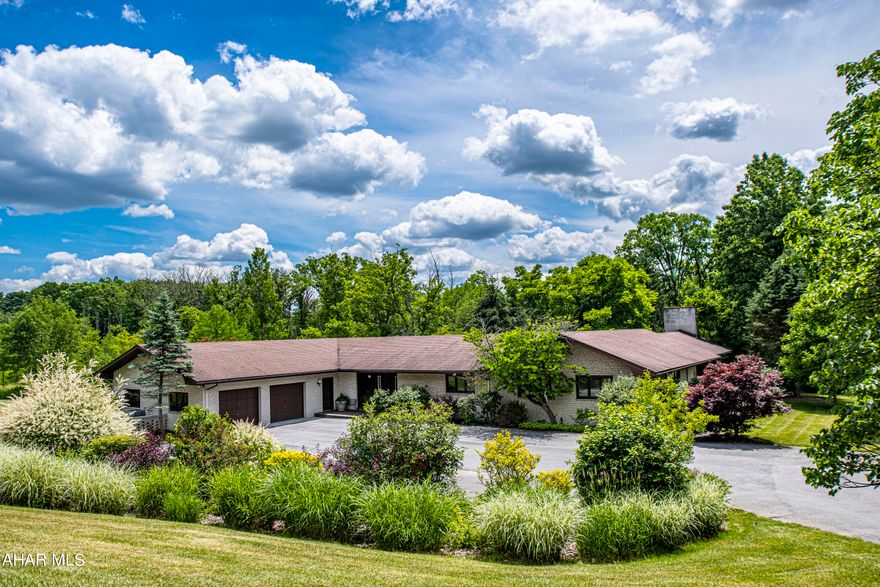 Welcome to your dream home in Allegheny Township! Nestled on a beautifully landscaped 3-acre lot, this stunning ranch-style property boasts 5 spacious bedrooms, including a luxurious master suite with an ensuite bathroom, a sauna, and a private deck. The junior master also features an ensuite bathroom, while the other three bedrooms provide ample space for family or guests.

The open-concept kitchen and living room are perfect for entertaining, with picturesque views of the outdoor patio and the tranquil 3200-gallon pond. The sunken family room, with its wood-burning fireplace, offers a cozy ambiance for relaxing in the evenings or taking in the natural beauty during the day.

The finished basement provides plenty of bonus space, with a family room, office, and a bar area that's perfect for entertaining guests. And with ample storage space, you'll have plenty of room to keep your belongings organized and out of sight.

But the perks of this home don't stop there. A private drive leads up to the property, and an invisible fence ensures your pets can roam freely. Plus, with the option to purchase an additional 1-16 acres of surrounding woodland, you'll have even more space to explore and enjoy.

With all of these features and more, this home truly has it all. Don't miss your chance to make it yours today, and enjoy schooling in the Hollidaysburg Area School District. Schedule your showing today and get ready to fall in love with this amazing property!