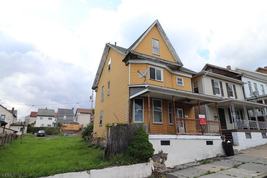 4BR 1BA home on a double lot being sold as-is in need of TLC. Sale includes adjoining vacant lot which has a concrete off street parking pad in the rear.