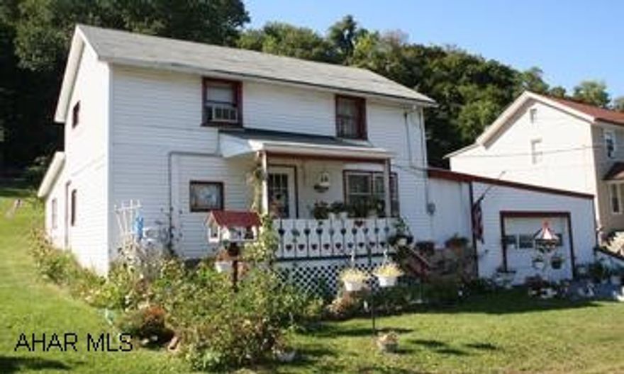Single family home with gardens, both flower and vegetable. House could also be a 2-unit rental, upstairs has kitchen / living room, bedroom and bath.