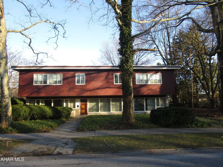 One of Blair County's most unique residences. this mid-century modern home is  located in historic Mansion Park.  Constructed of steel and concrete, the one owner home features an elegant sunken living room, formal dining room, den with wet bar, main floor laundry room with appliances.  Note marble windowsills throughout.  Six graciously sized bedrooms, three full baths and endless closets throughout the second floor.  Cozy hot water heating.  Private rear flagstone patio to enjoy the coming warm summer days.  Two car garage with additional storage and furnace room.