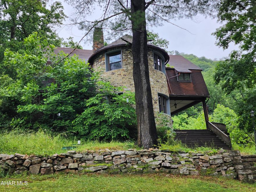 Finally! Your Castle in the woods, in Point View! Royalty meets Rustic in the spacious hill-side cottage. This home was beautifully crafted with stone works around the whole property - walkways, retaining walls, and stone built home! 4 spacious bedrooms, 2 full bathrooms, first floor laundry. Spacious 1 car garage. Ample storage throughout. Large deck, partially covered. Wood burning fireplace. Tons of natural lighting and high ceilings. A little TLC will go a long way! So much original charm here! $90 monthly association fee which includes 220 acres of community-shared land that can be used for hunting, camping, hiking; and sewer and well use/maintenance! Call for your tour today!