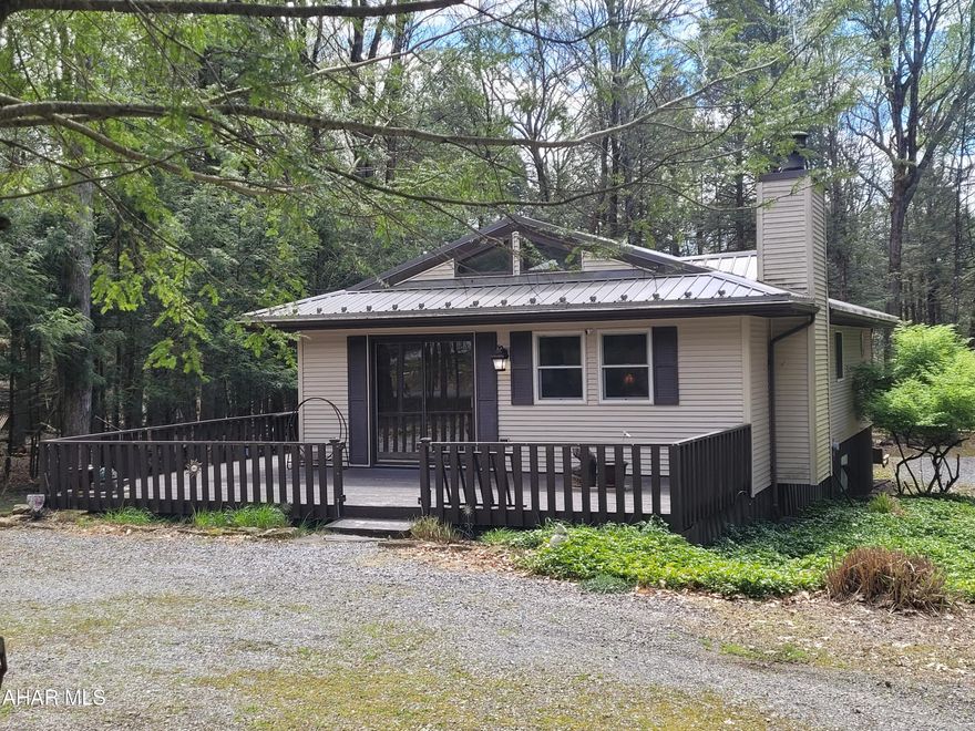 One level cabin for full time living or weekend adventures.  Three bedroom, two baths, laundry, eat in kitchen and living room check all of the necessities.  But don't forget the extras: the wood fireplace to cozy up to on cold winter days or nights, the huge deck that surrounds the home on three sides and the great sunroom on the back of the home that bridges the main bedroom and the sprawling back deck.  Set in the middle of 1.5 acres offers you privacy for you and the wildlife that you will be watching.