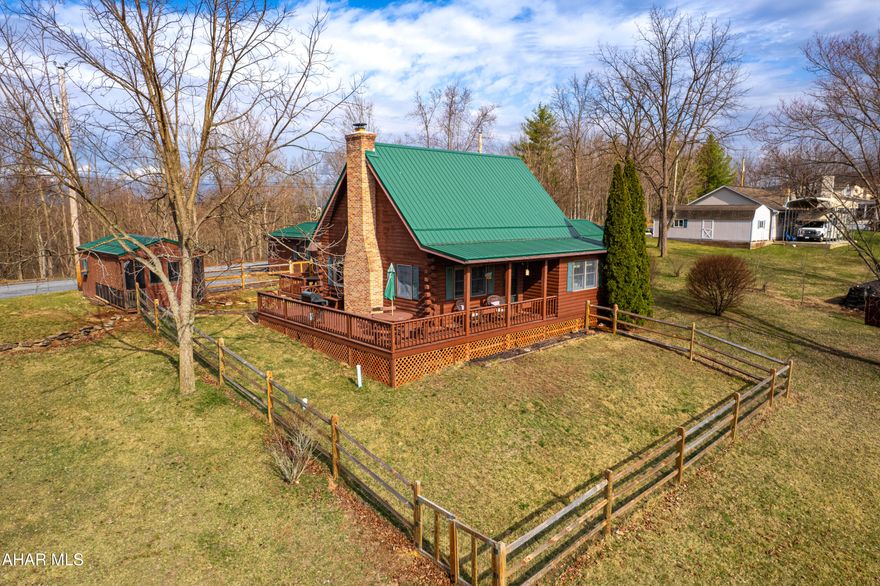 Step into the warm embrace of this renovated 3 bedroom, 3 bathroom log home, where rustic charm meets modern comfort. 

The heart of the home is the inviting living room, boasting soaring cathedral ceilings and a magnificent stone fireplace—perfect for cozy evenings by the fire. Overlooking this charming space is a beautiful loft, adding character and home office or third  bedroom to the home.

The newly renovated expansive master suite is a true retreat, complete with a spacious sitting area and a newly renovated private ensuite bathroom for ultimate relaxation and walk in closet.  For added convenience, a main-floor laundry room is located just adjacent to the master bedroom, making everyday living effortless.

Enjoy your morning coffee, an evening meal, or a peaceful breakfast on the wraparound porch, where you can take in the fresh mountain air and stunning views.

For guests, a newly renovated separate guest house offers privacy and comfort, featuring its  own bathroom and private entrance. A fenced yard provides a perfect space for pets or simply enjoying the tranquil surroundings.  

Nestled in the breathtaking Alleghany Mountains, this property in historic Bedford County offers lovely views and endless opportunities to soak in the natural beauty. Whether you're seeking a full-time residence or a weekend getaway, this remarkable home is a peaceful haven in an enchanting setting.