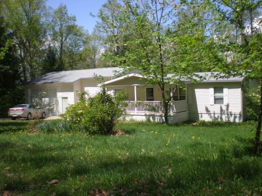 Doublewide with addition and attached oversized garage on a nice country setting near Prince Gallitzin State Park. Wooded lot.
