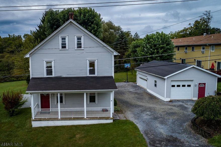 This spacious 4-bd, 2 bath home is a stone's throw from YPCCs and the Ghost Town Trail.  Nicely updated, and move-in ready.  You'll love the flat 1/2 acre lot that is fenced along 3 sides; the upscale playhouse; the pergola; greenhouse; 3-car garage; the 2-tiered patio; the well-built retaining walls; and the private driveway.  The inside is modern and inviting.  You'll enjoy entertaining in the large kitchen that opens to the breakfast nook.  Homemade radiator covers, ss appliances, island, pot rack, pull-out drawers, lazy susan, recessed lights, lighted ceiling fans, chalkboard walls, and a walk-up attic. Zoned 'Mixed Use Village Commercial.'  This property qualifies for a USDA loan (no money down). Average Gas, $120; Electric, $110 w/hot tub; water/sewer/trash, $235 every 2 months.