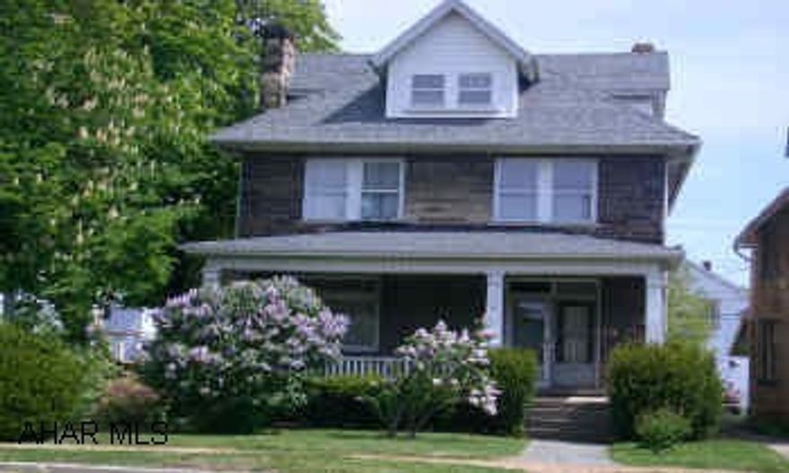 Charming and stately stone home on corner  lot. Large rooms, 9 ft ceilings, updated kitchen, central heat and AC. Fenced back yard, detached 2-car garage. Lots of space and character.Call Carol before setting up showing. (Estate Sale going on for a couple of weeks)