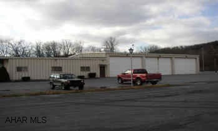 FORMER FIRST ENERGY HEADQUARTERS.  STEEL AND BLOCK BUILDING.  LARGE FENCED STORAGE YARD.  MULTI-PURPOSE OFFICE, GARAGE AND WAREHOUSE ALONG US 220.  POSSIBLE REAL ESTATE TAX DEDUCTION.  3120 SF OFFICE/4833 SF WAREHOUSE.  REAR FENCED STORAGE YARD, LIGHTED 3 BAY TRUCK GARAGE, CEILING HEIGHT 16 FT.