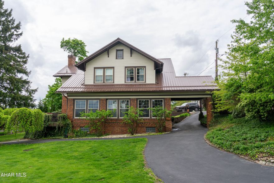 Looking for a very special home - plus the perfect setting for entertaining?  Come see this classic brick beauty offering a newer kitchen with appliances included, huge living room with gas fireplace, hardwood floors and beamed ceiling, spacious enclosed porch with panoramic views, sitting room/office which could double as a guest room with adjacent full bath, game room with bar, and half bath.  The second floor features four large bedrooms, 1 1/2 baths and laundry room.  Beautiful yard area with hot tub, firepit, shed and off street parking for multiple vehicles.   Roof replaced in 2024, newer water line and hot water heater.  Updated furnace.  Make your appointment now to see this wonderful home!

Driveway runs length of the property and accesses the alley to prevent need to back out on to the street.