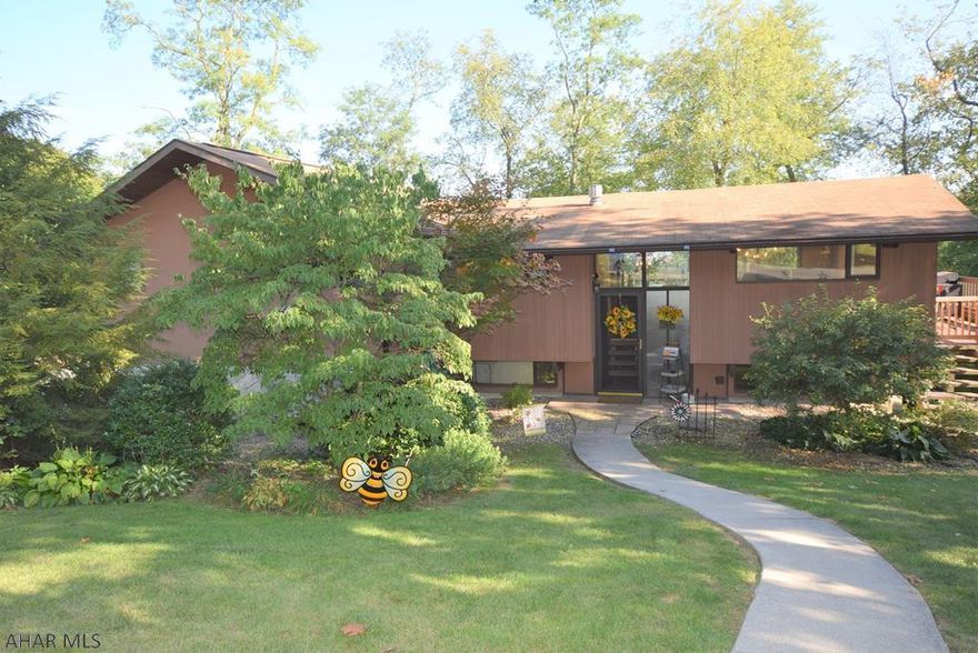 Open floor plan, newly updated kitchen with granite counter tops, copper sink,  and less than two year old stainless appliances.  New Armstrong Pryzm waterproof flooring on main floor.  Both kitchen and dining room have doors to wraparound deck.  Living room with vaulted wood and beamed ceiling,  AC and heat wall unit.  Master bedroom features over sized walk-in closet, door to deck, modern master bath with garden tub and separate shower.  All three main floor bedrooms have new Fujitsu wall AC and heating units.  New ceiling fans.  Main heating source is 4 zone gas hot water heat and the new Fujitsu units offer an electric back-up heating source.  New retaining wall along driveway.  Large yard with shade trees.