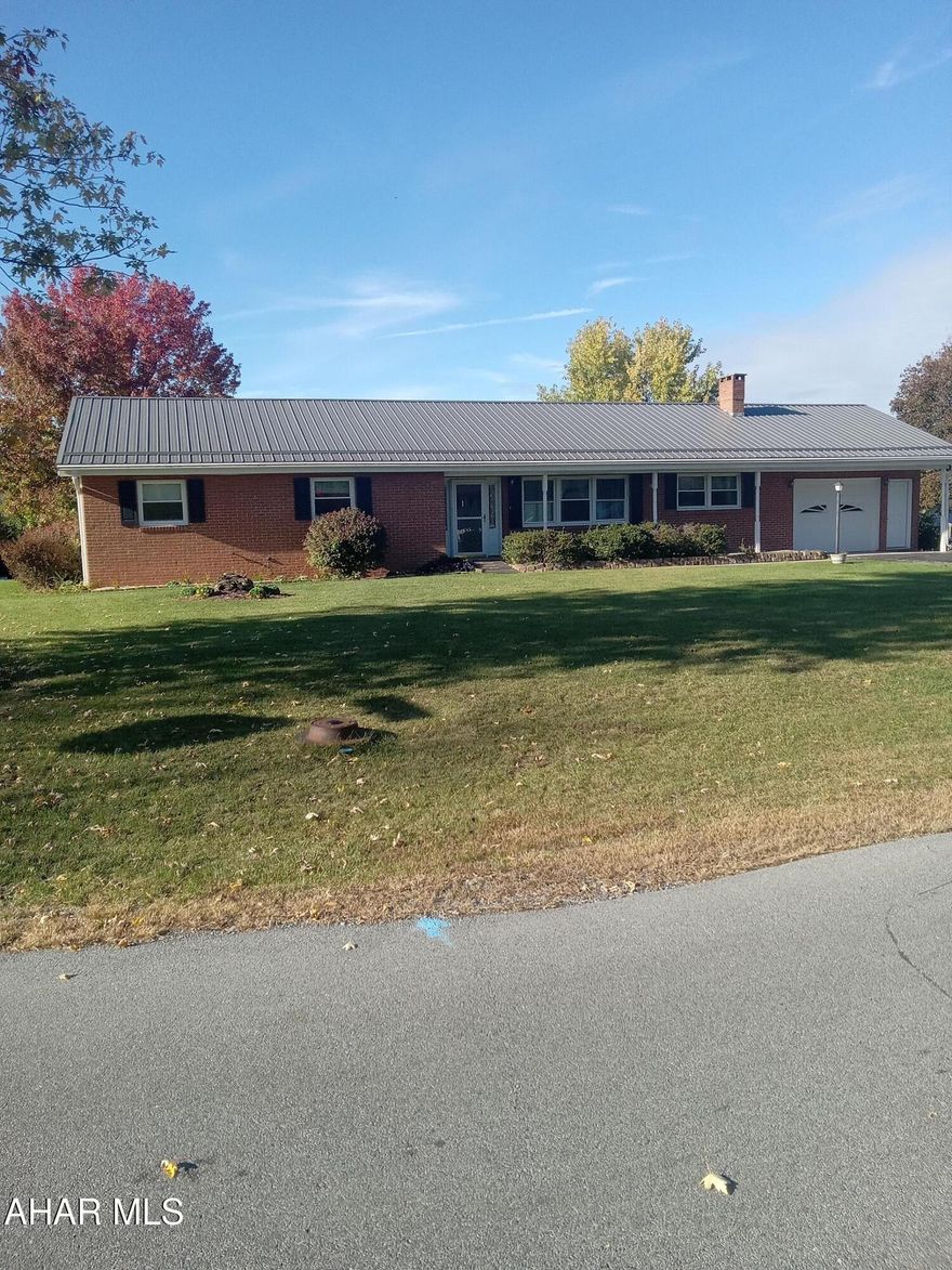 Must see brick and vinyl rancher on a corner lot in Penn Farms.   The original design was a 3-bedroom 2 full bath rancher however one bedroom was changed into a large laundry room which could be return to a bedroom.  The house was built over a crawl space,.  There is a large concrete rear patio a portion of which is under cover.  The one car garage is quite large.  The kitchen features white cabinetry and appliances.  The family room boasts a wood burning fireplace and has access to the rear patio and garage.
