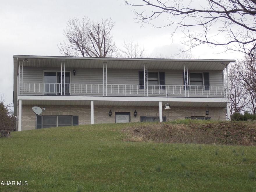 WHAT A VIEW from this 2,600 sq ft raised ranch in Rolling Hills, sit on the front porch and you can see for miles.  This 3 BR/3BA home sits on an acre lot and has great space for both family and guests.  
 The basement with a family room, full bath and a bedroom makes the perfect space for an in law suite or to have friends hang out.  The laundry room is on this floor as well. 
Wait until you see the size of the Master BR and the walk in closet on the main level, wow! The guest room is large and the hall bath is right next door so, very convenient.
The living room on the main level has a spectacular view with double doors leading out to the porch. The sunroom is perfect and adds lots of extra living space, it's heated too.
A few personal touches and this house may be the perfect home for your family.