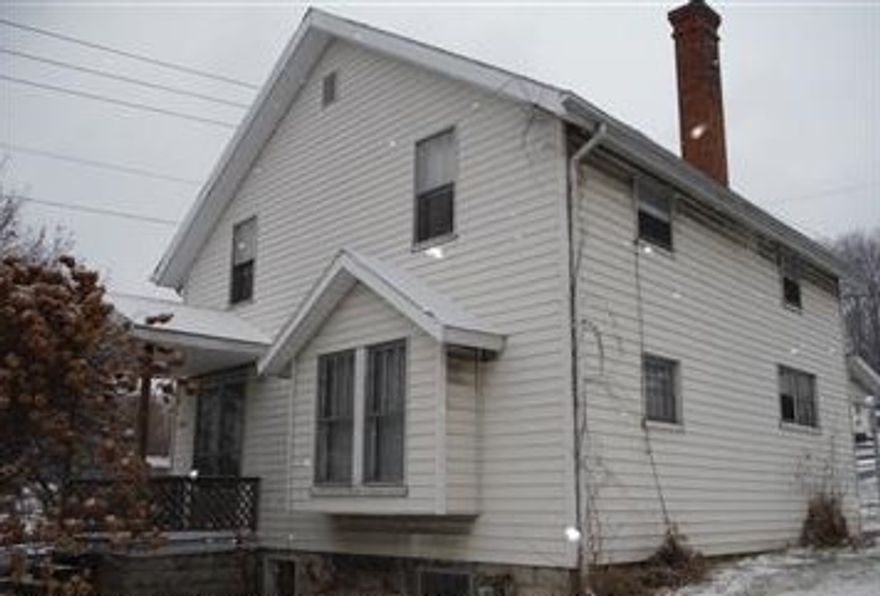 Nice, solid fixer upper. Exterior has vinyl siding and a newer roof. Interior needs a new kitchen and each room needs painted. First floor features hardwood floors. Home is situated on a corner lot. Nice size lot with room for a garage.