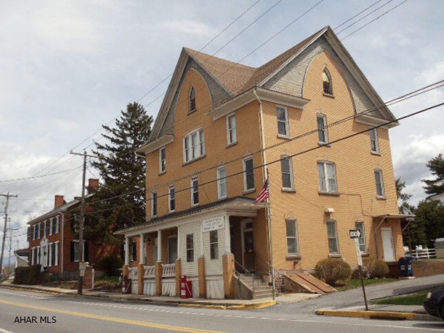 Fixer-upper with lots of potential.  Beautiful brick building overlooking neighboring pond & country view.  Natural woodwork, currently 3 apts. & (post office rents for $522/mo.),  plus there is a 3rd-floor ballroom, and full basement.  #J-060