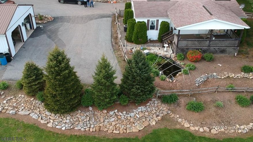 Over 4.5 acres of country living at an affordable price. Paved driveway and parking area with a 3 car garage. Enjoy the lush fields and even a pond. Enjoy the wonderful views of the mountains from the comfort of your covered front porch. There is a stream and a large garden as well as a picnic pavilion and even a chicken coop. The possibilities are endless.