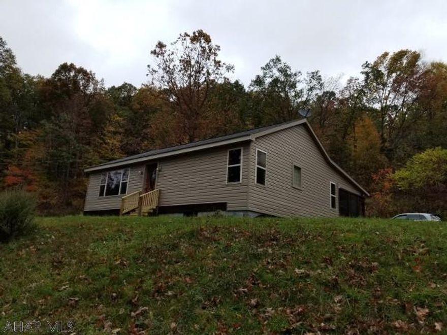 Ready to move in.  2 bedroom rancher on 4.43 acres in Decker Hollow. Hardwood floors. Fireplace in living room. Oil hot water baseboard heating system. Garage.