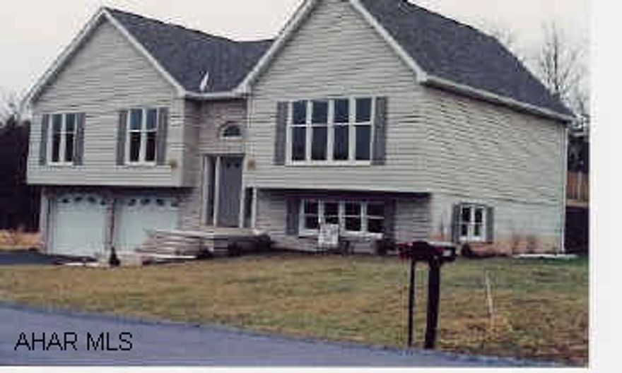 Split entry with Alpine roof design. Diningroom and master bedroom open onto deck.