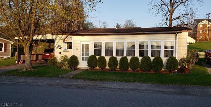 LIKE NEW DOUBLE WIDE WITH SUNROOM ADDITION.   CARPORT AND RAMP FOR EASY ACCESSIBLITY.  BEAUTIFUL NEW KITCHEN AND BATHS.  NEW LAMINATE FLOORING.  NEW FURNACE AND WINDOWS.  VAULTED CEILINGS.  LOW TAXES.  $325 LOT RENT.   BEAUTIFUL HOME READY FOR YOU TO MOVE IN AND ENJOY!