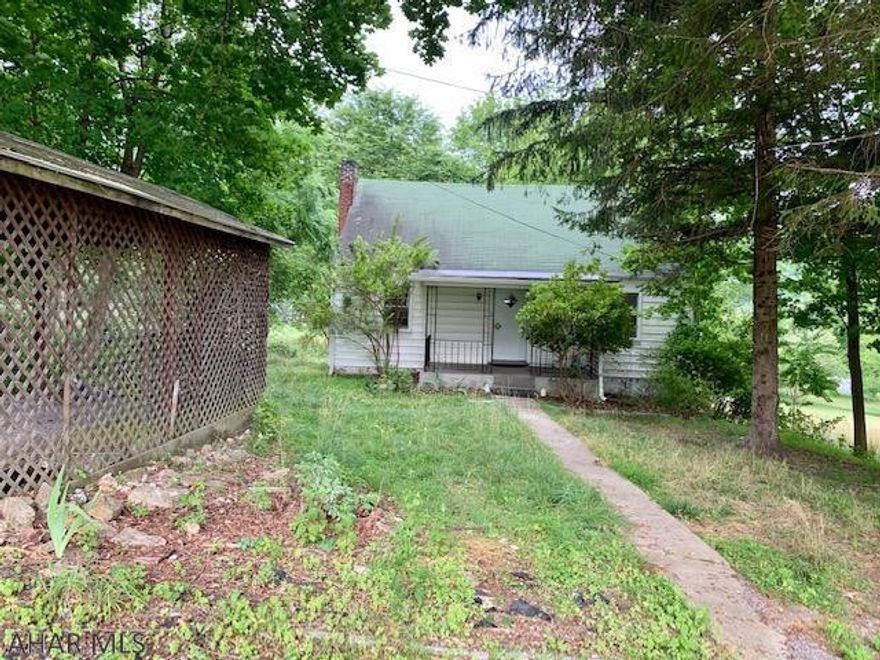 Private and wooded Cape Cod home with lots of potential and a great location!  With TLC  this home can be restored to its quaint state.  Located in Bedford Borough and amenities at your fingertips.  Easy access and with-in walking distance to the historic downtown.The home offers a nice open foyer, hardwood floors, built-in china cabinet, a carport, covered front porch and covered back deck!!