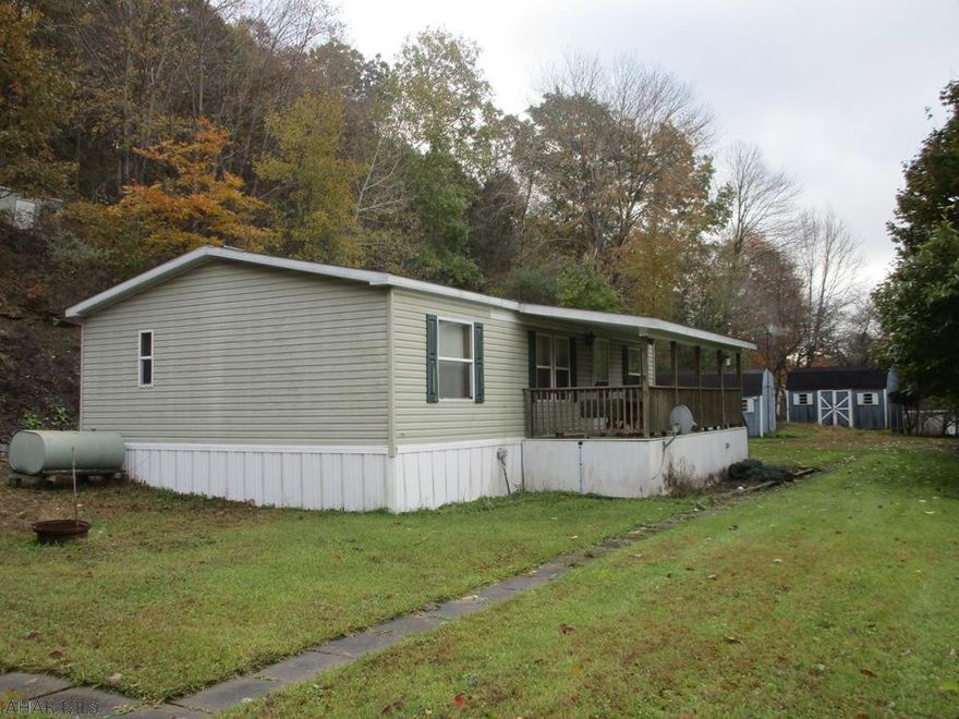 A short distance to Prince Gallitzin State Park this 5.1 acre property has a double wide and a single wide on it. Homes appear in good  condition and were used as a family summer get away. Three sheds and a carport are on site. Acreage is wooded.