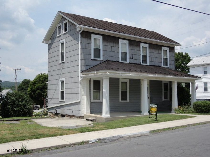 Being Sold As Is. Great corner lot with 2-story house, replacement windows, 200 amp service, private well, public sewer and full basement w/exterior entrance. Plus workshop. 2-stg bldgs.