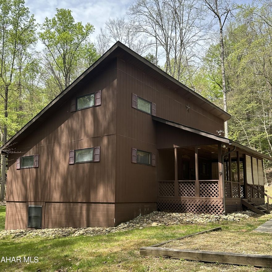 Cozy and private 3 Bedroom nestled in a gated community. Walking distance to the pool, community park, basketball court and clubhouse. Enjoy nature with walking trails nearby. Abundant wildlife throughout the community and even in your own back yard. Entertain on the large back deck, have coffee in the morning on the front porch or build a fire in the fire ring. Plenty of hardwood still on site. This would be a great second home or permanent residence. Included in this sale is a second lot to the right of the house. The HOA fees of $910.13 are for both lots. Call Listing Agent for gate access.