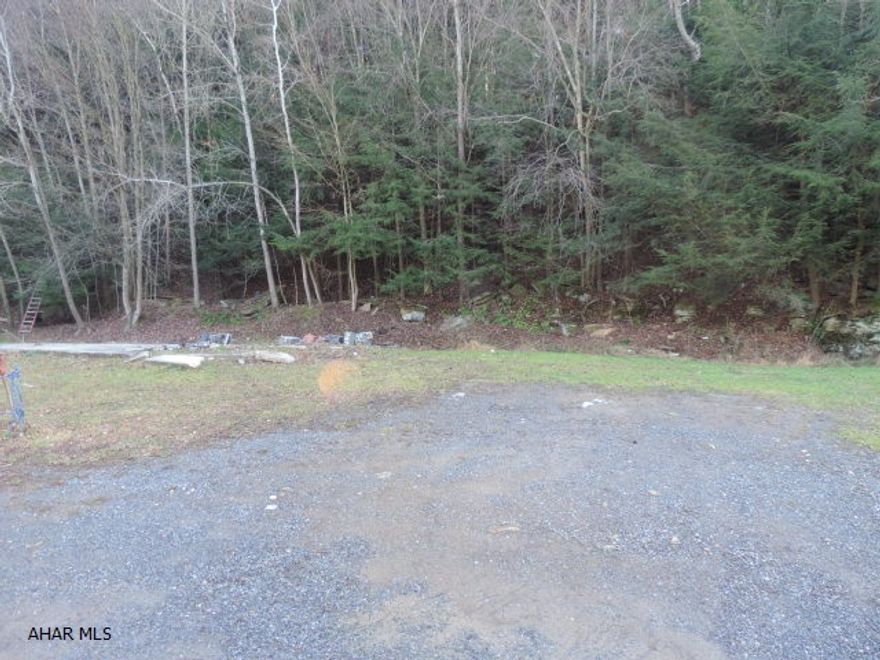 This is a empty campsite at Glendale Yearound. It has water and sewer already on site. Electric, cable, and telephone are available. The lot is flat and in a more private area. There is a cement pad on site. The lot needs a little cleaning up.