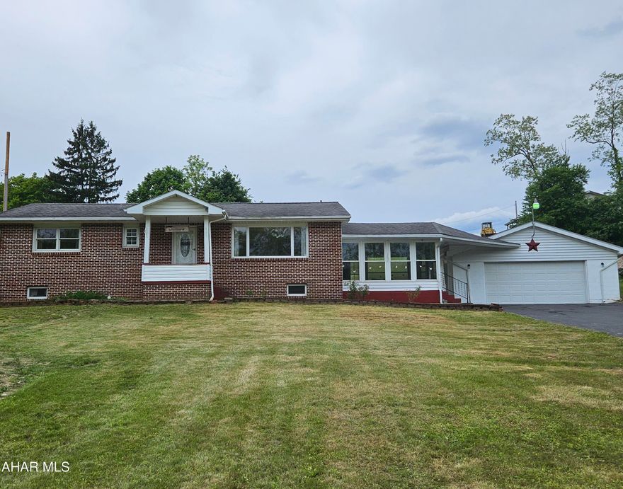 Sweet brick and vinyl 1 story in Antis Township!  2 large bedrooms, 1 updated tile bath, main floor laundry, eat-in kitchen with all appliances and great heated sunroom addition that leads to the 25 x 27 2 car garage!  The basement is partially finished with an interior french drain and sump pump.  100amp electric.