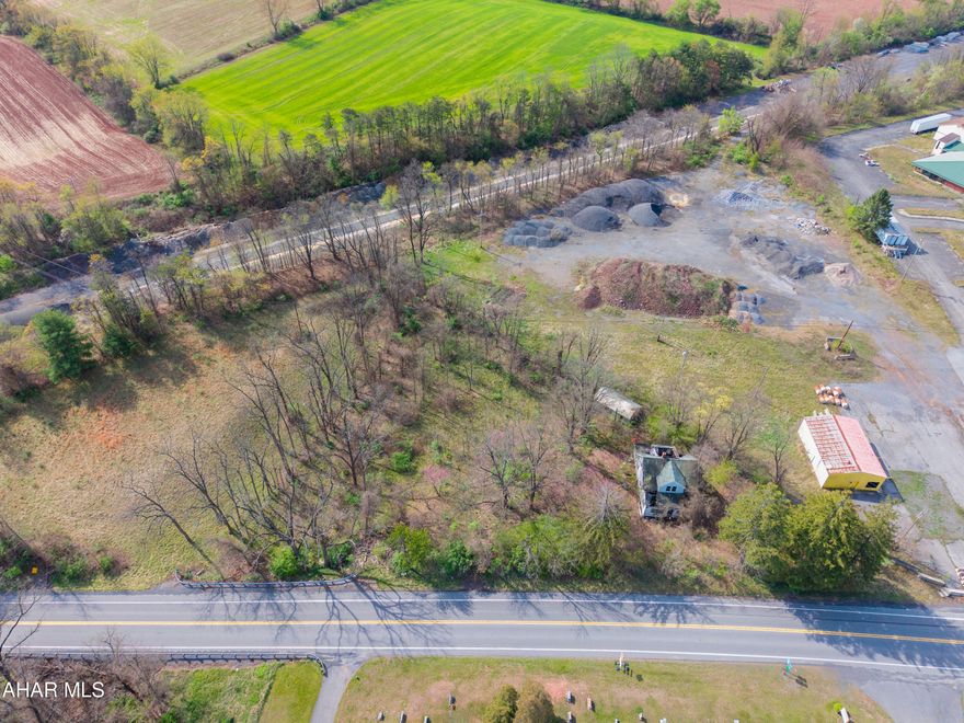 This lot contains .99 of an acre with public sewer and an older well. It is situated very close to the PA Abandon Turnpike parking which offers walking, biking, running, and features the End of the Road Half Marathon. This lot could have many uses including commercial, residential, or even a getaway cabin/camp. Located just steps from Breezewood's restaurants, convenience stores, hotel/motels, I-70 and the turnpike interchange. There is an old home that has not been occupied in many years, and it should be removed from the site. There is also a 13' x 24' garage.